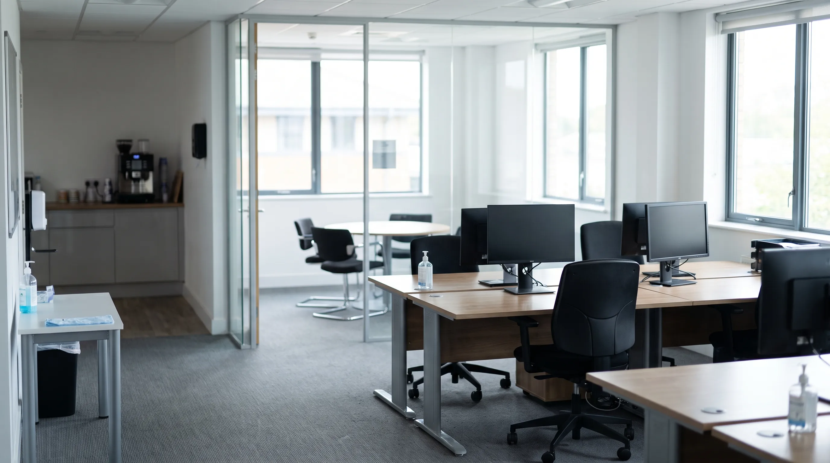 Clean open-plan office with workspaces and shared areas that need different cleaning frequencies